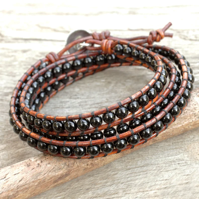 Bangle bracelets with braided leather straps for a chic, rustic vibe-Surin Night Onyx and Leather Wrap Bracelet with Hill Tribe Silver Clasp